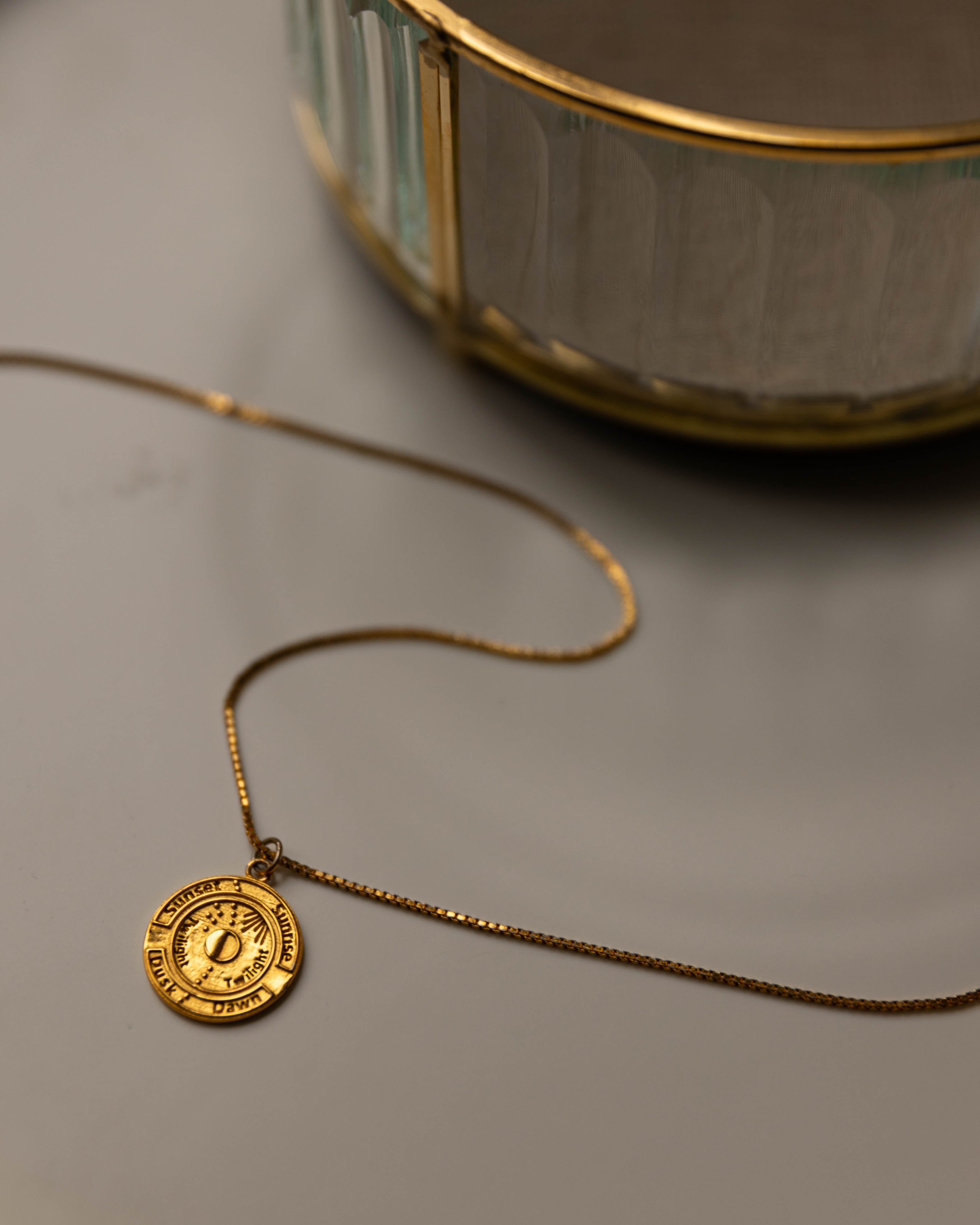 Close-up of Aega gold vermeil medallion necklace showing the rich warm tone of 18K gold — why we chose 18K purity
