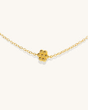 gold chain necklace with small flower pendants along the chain womans jewelry