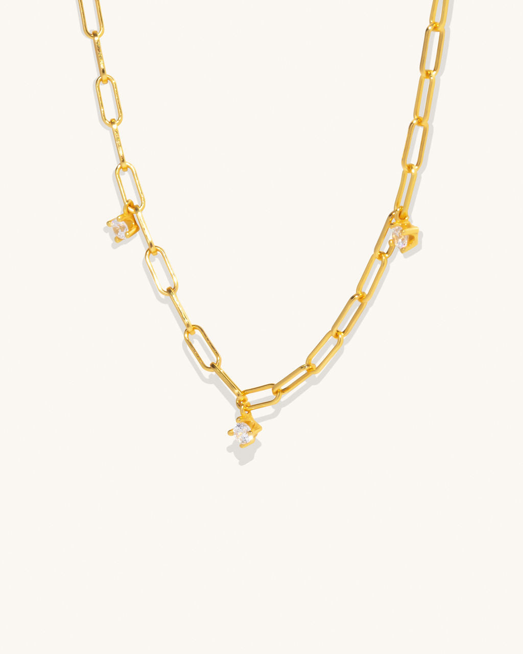 gold chain links that connect with 3 diamond pendants attached hanging off along the length of the chain jewelry womans fashion