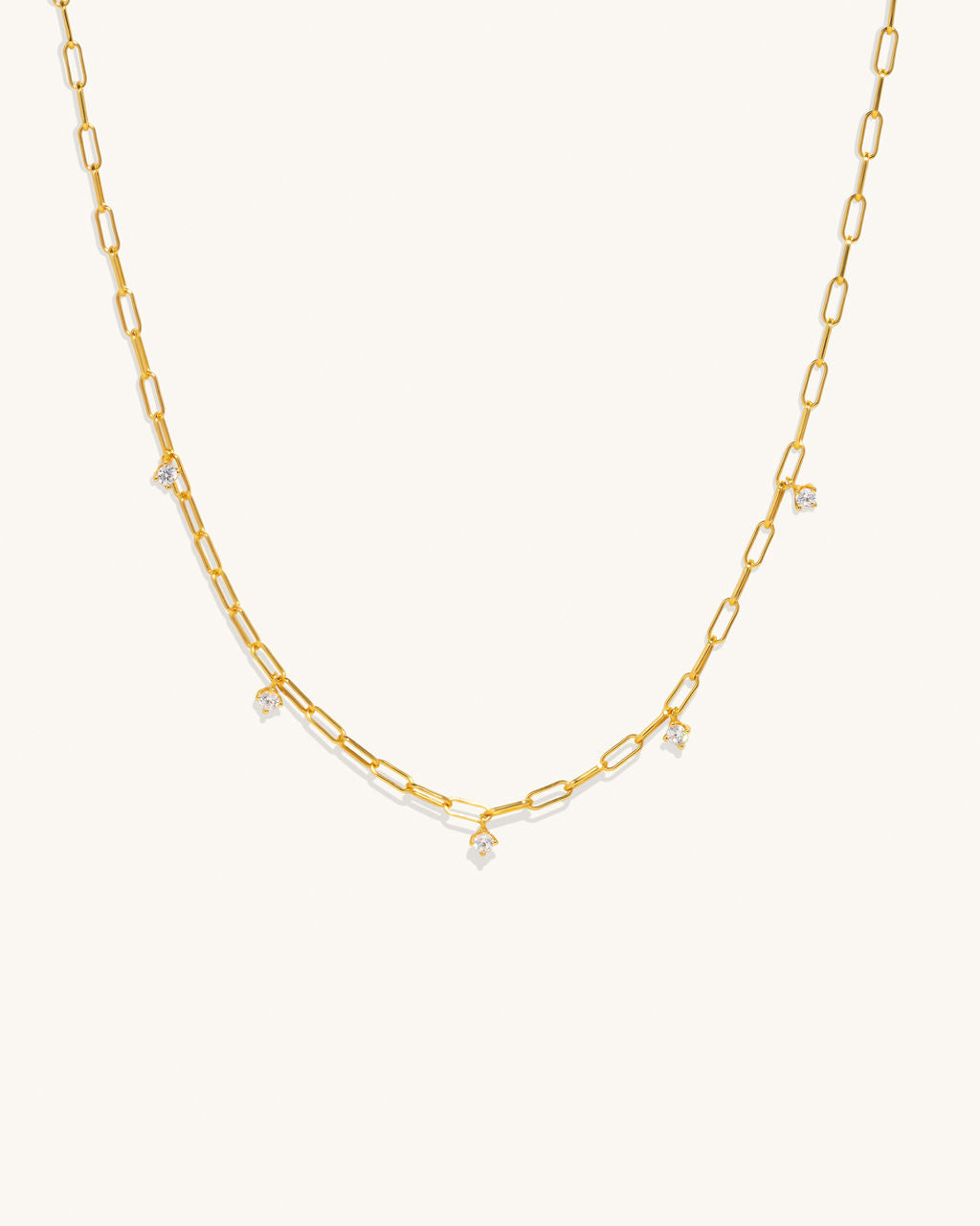 gold chain links that connect with 3 diamond pendants attached hanging off along the length of the chain jewelry womans fashion